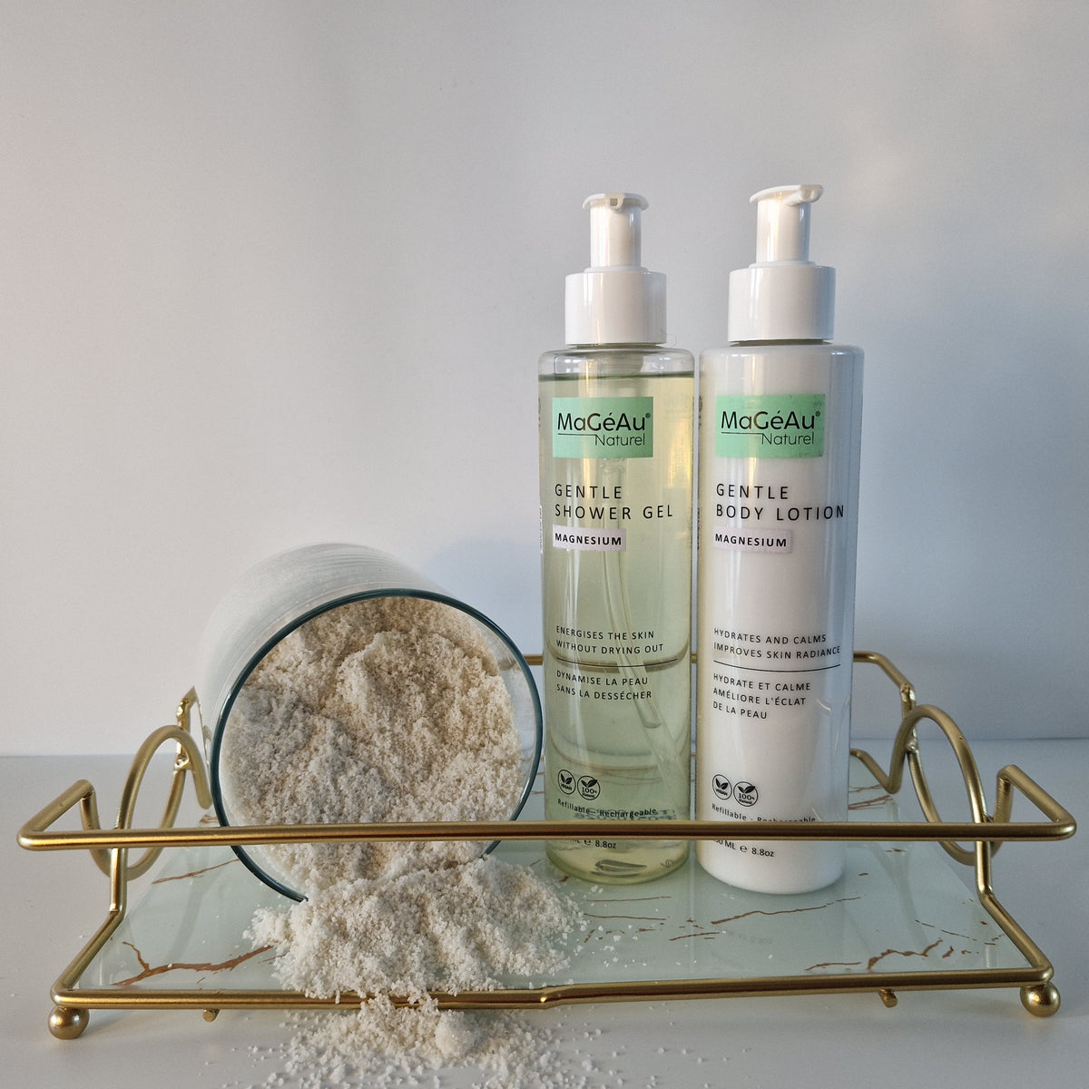 Two bottles of Mageau naturel magnesium  skincare products on a gold tray with a white background