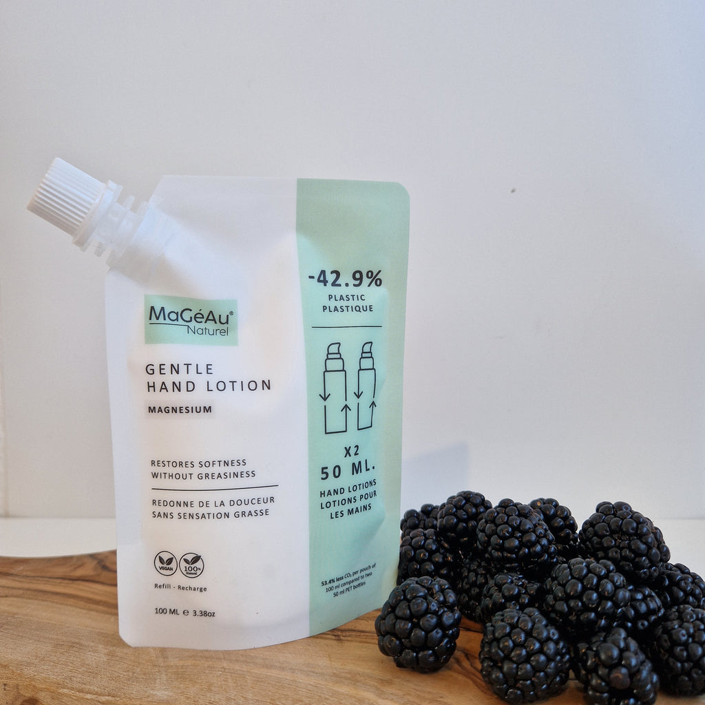 Mageau naturel magnesium Hand lotion tube with blackberries on a wooden surface