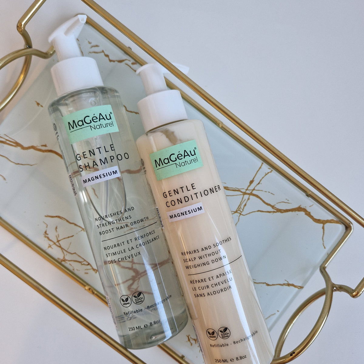 Two bottles of Mageau naturel magnesium  Gentle Shampoo and Gentle Conditioner on a decorative tray.