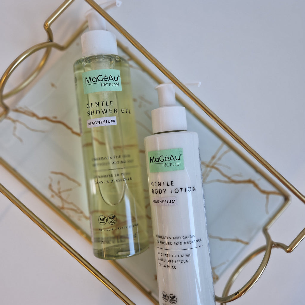 Three bottles of Mageau naturel magnesium skincare products on a decorative tray with a marble background.