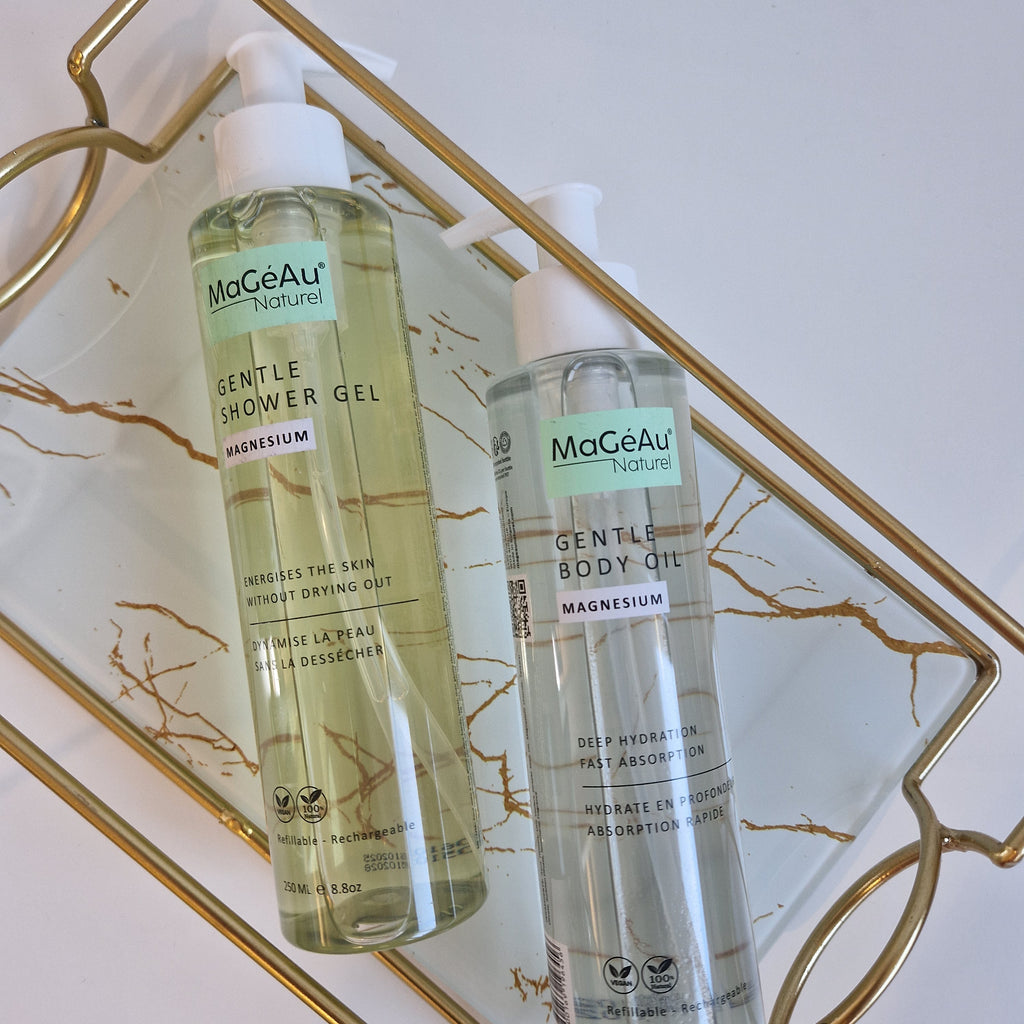 Two bottles of Mageau naturel magnesium  skincare products on a decorative tray with a marble pattern.