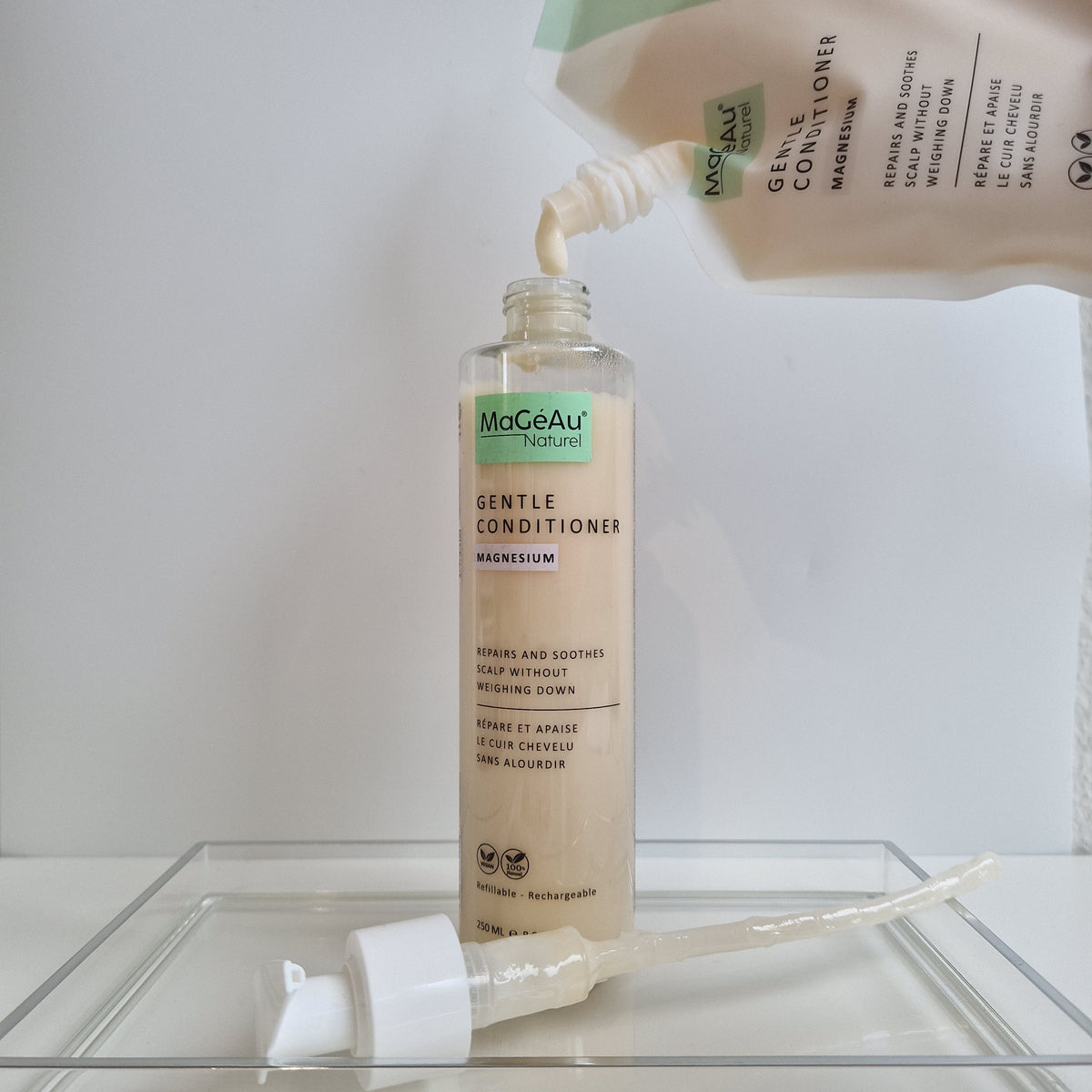 MaGéAu Naturel Gentle Conditioner bottle being filled with a pump on a white background